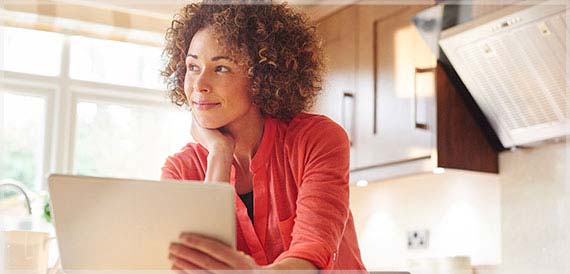 Woman checking her estatements on her tablet.