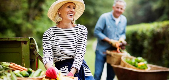 Couple working in vegetable garden.