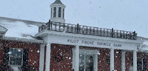 Pilot Grove, Iowa snow falling on Pilot Grove Savings Bank branch in winter.