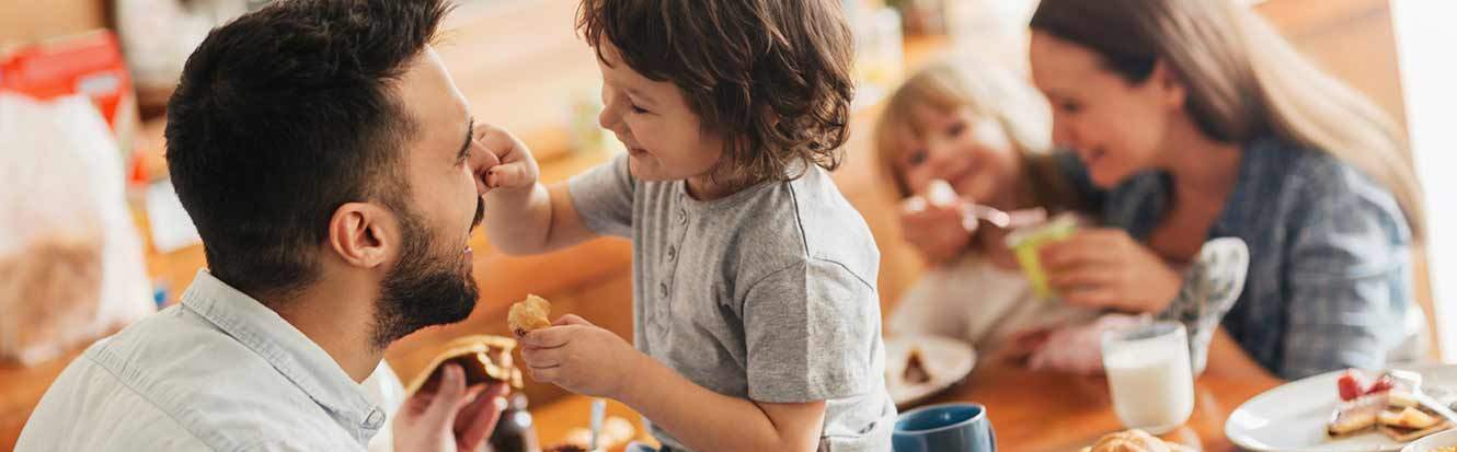 Family eating breakfast together because they do mobile banking with Pilot Grove Savings Bank and have more time for special moments