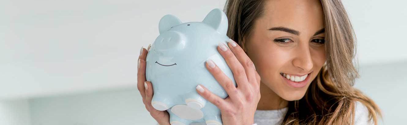 Girl holding a piggy bank after getting a savings account with Pilot Grove Savings Bank