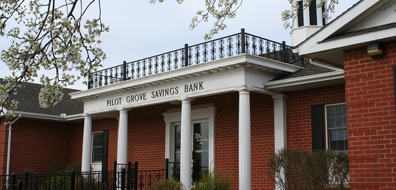 Pilot Grove Savings Bank home office photo in spring with blooming flowers.