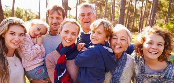 Many generations of smiling faces in a family photo