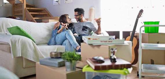 Couple relaxing in their new home as they unpack after financing a new loan with Pilot Grove Savings Bank